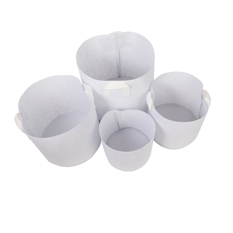White non-woven planting bags with two handles
