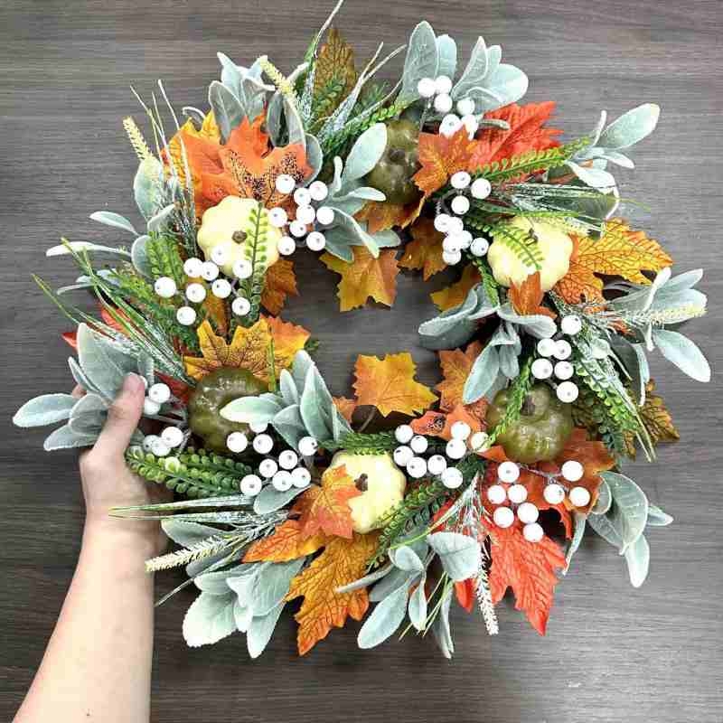 Plastic white pumpkin and maple leaf wreath